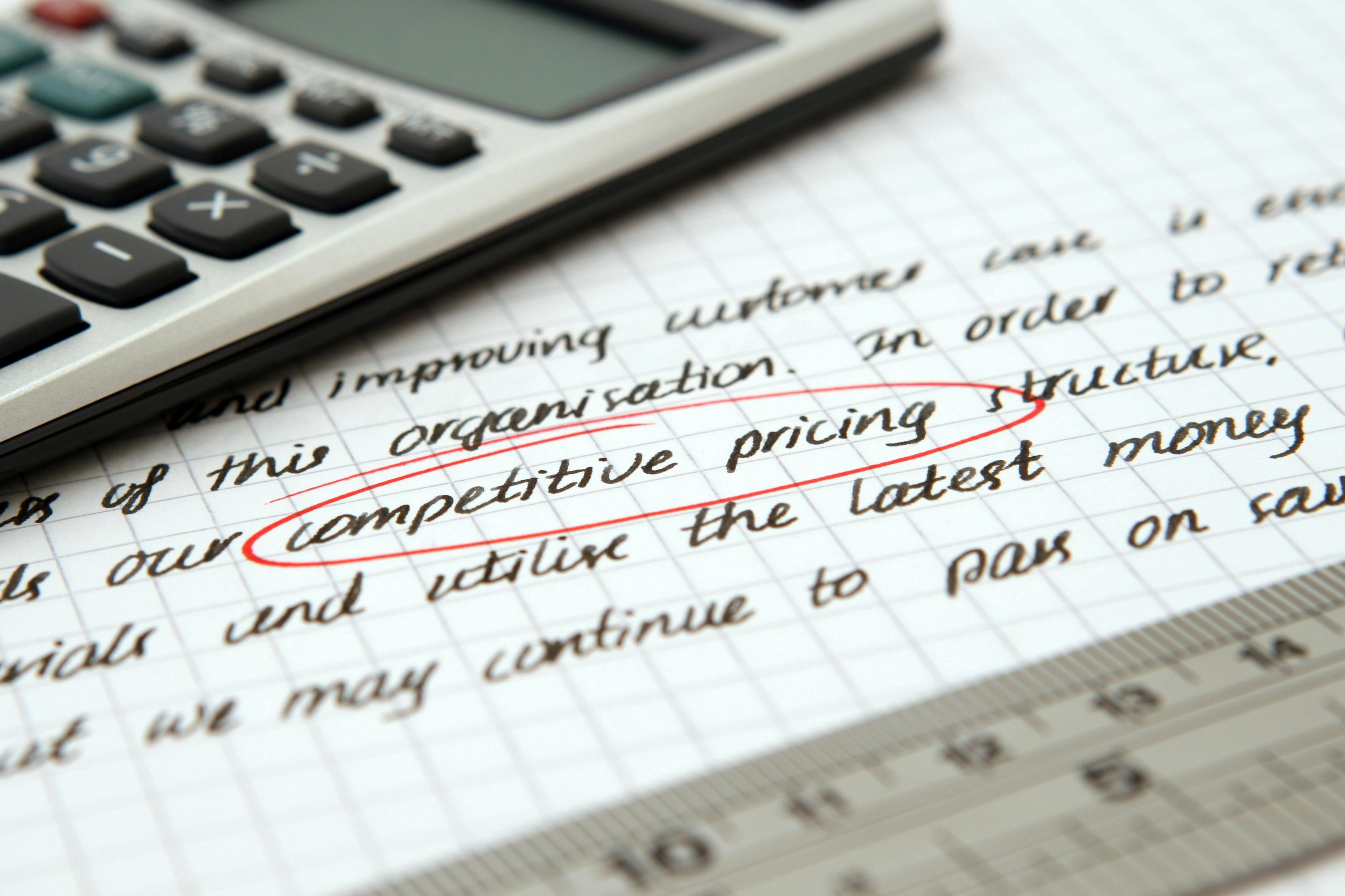 Calculator on paperwork representing structured pricing review